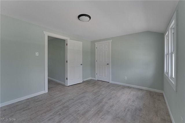 533 12th St, Campbell, OH 44405 - unfurnished room featuring wood finished floors and vaulted ceiling