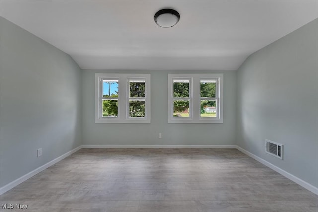 533 12th St, Campbell, OH 44405 - spare room with healthy amount of natural light, wood finished floors, and lofted ceiling