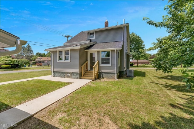 533 12th St, Campbell, OH 44405 - view of front facade with a chimney, a front yard, and a shingled roof