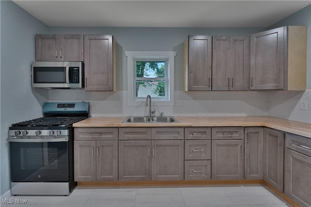 533 12th St, Campbell, OH 44405 - kitchen featuring appliances with stainless steel finishes, light countertops, and tasteful backsplash