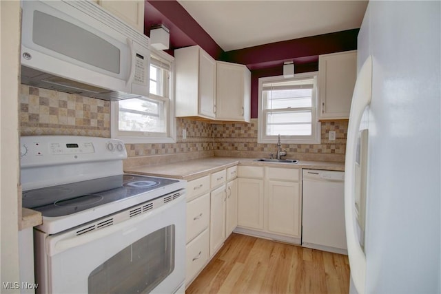 4606 Maplecrest Ave, Parma, OH 44134 - kitchen featuring white appliances, light countertops, light wood-style floors, and plenty of natural light