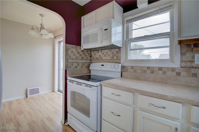 4606 Maplecrest Ave, Parma, OH 44134 - kitchen with white appliances, a chandelier, light countertops, tasteful backsplash, and white cabinetry