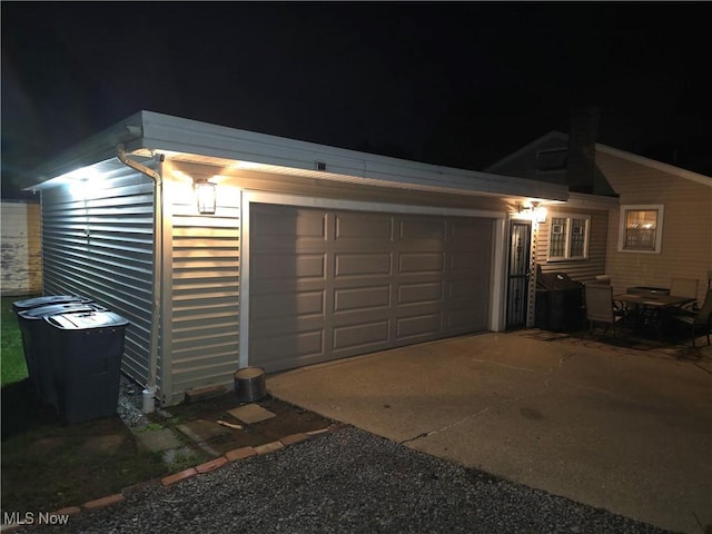 72 S Hartford Ave, Youngstown, OH 44509 - garage at twilight featuring concrete driveway
