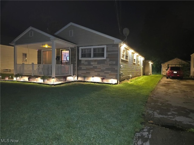 72 S Hartford Ave, Youngstown, OH 44509 - view of front of house featuring a lawn, a porch, driveway, and an outdoor structure