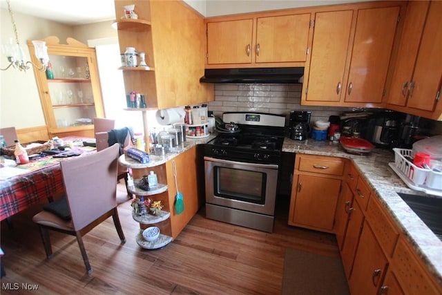 72 S Hartford Ave, Youngstown, OH 44509 - kitchen featuring under cabinet range hood, open shelves, stainless steel gas stove, a chandelier, and backsplash