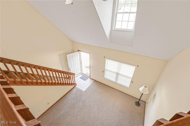 11253 Hampton Bay Ln, Concord, OH 44077 - unfurnished living room featuring carpet flooring, stairs, and high vaulted ceiling