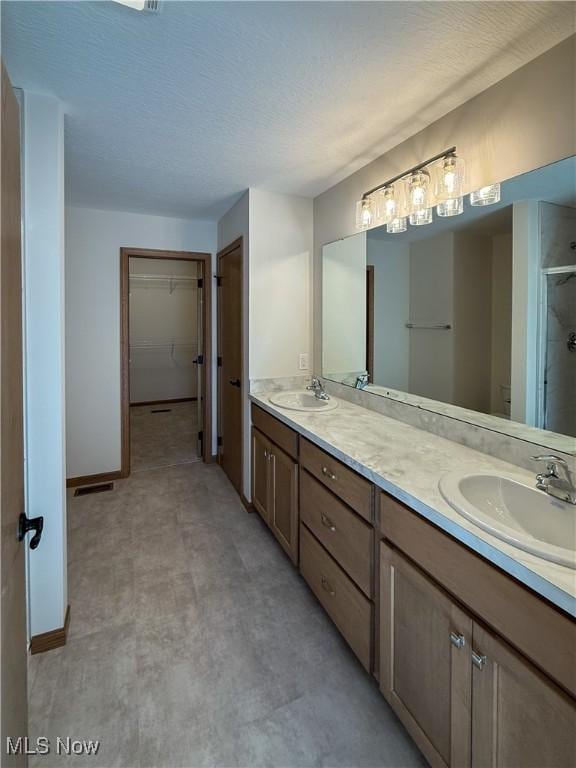 700 Whitetail Crossings, Wooster, OH 44691 - bathroom featuring a stall shower, double vanity, tile patterned floors, and a spacious closet