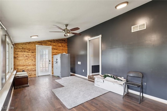 1811 Stepney St, Niles, OH 44446 - living area featuring lofted ceiling, dark wood-type flooring, a ceiling fan, and wood walls