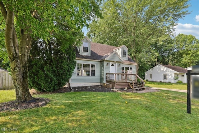 1811 Stepney St, Niles, OH 44446 - cape cod-style house with a wooden deck, a front yard, and a shingled roof