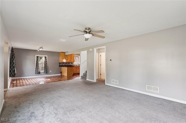 1811 Stepney St, Niles, OH 44446 - unfurnished living room featuring carpet floors, ceiling fan, and stairway