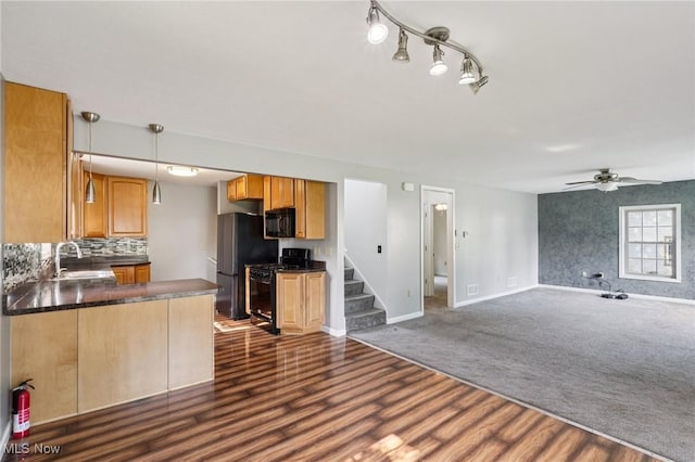 1811 Stepney St, Niles, OH 44446 - kitchen featuring black appliances, dark countertops, open floor plan, dark wood finished floors, and ceiling fan