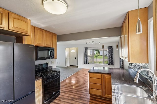 1811 Stepney St, Niles, OH 44446 - kitchen featuring black appliances, dark wood finished floors, open floor plan, hanging light fixtures, and dark stone countertops