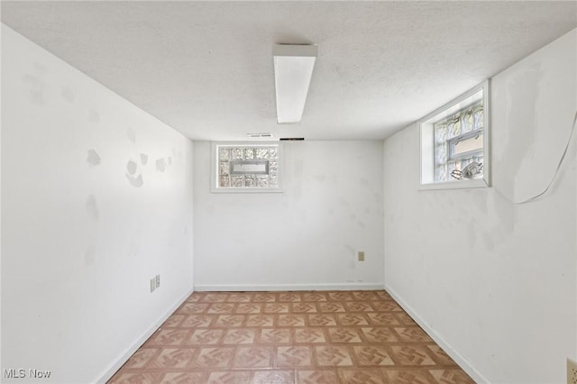 1811 Stepney St, Niles, OH 44446 - below grade area featuring a textured ceiling and light floors