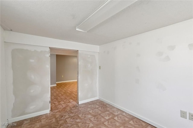 1811 Stepney St, Niles, OH 44446 - unfurnished room with baseboards and a textured ceiling
