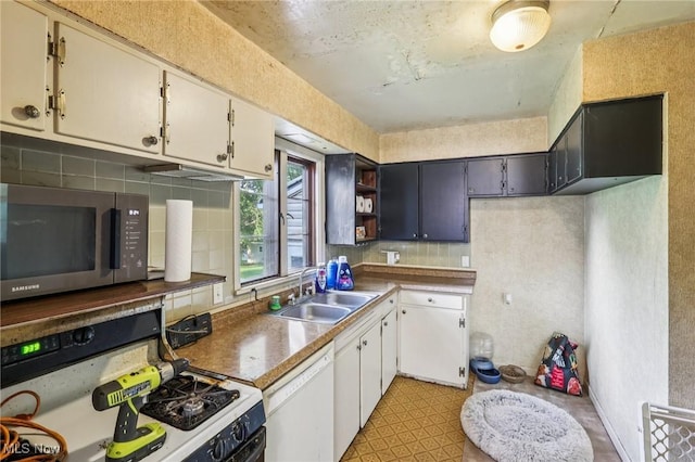 2992 Eldora Dr, Youngstown, OH 44511 - kitchen featuring gas range, stainless steel microwave, white dishwasher, backsplash, and open shelves