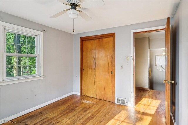 2992 Eldora Dr, Youngstown, OH 44511 - unfurnished bedroom featuring wood finished floors, a closet, and ceiling fan