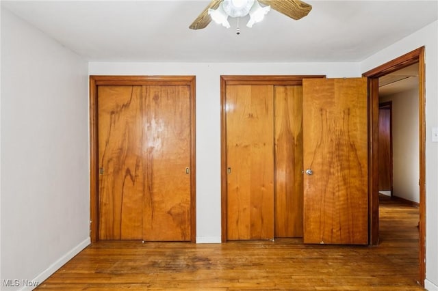 2992 Eldora Dr, Youngstown, OH 44511 - unfurnished bedroom with two closets, wood finished floors, and ceiling fan