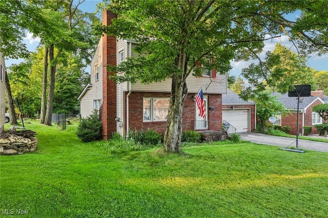 2992 Eldora Dr, Youngstown, OH 44511 - view of front of house featuring asphalt driveway, brick siding, a garage, and a chimney