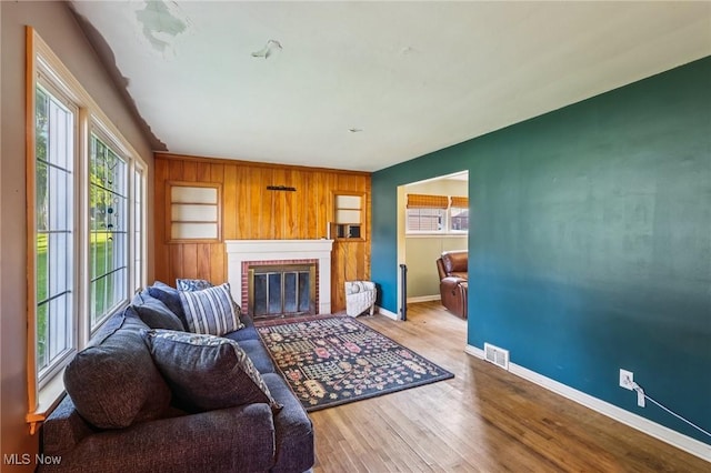 2992 Eldora Dr, Youngstown, OH 44511 - living area featuring healthy amount of natural light, a brick fireplace, and wood finished floors
