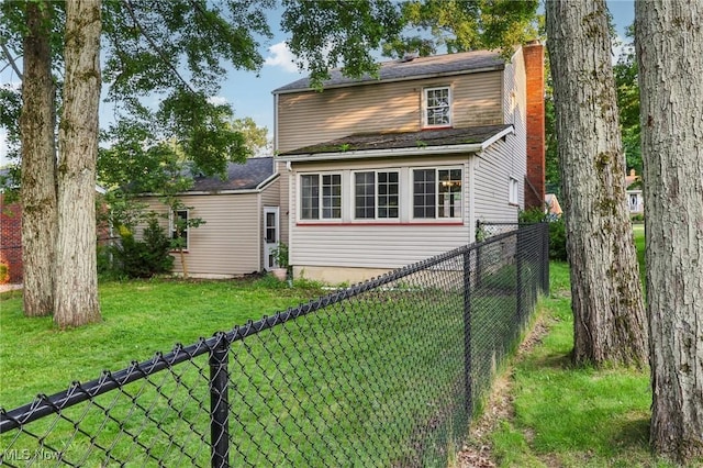 2992 Eldora Dr, Youngstown, OH 44511 - back of house featuring a fenced backyard and a chimney