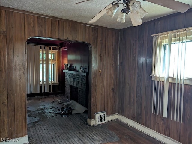 14717 Orinoco Ave, East Cleveland, OH 44112 - living area with ceiling fan, healthy amount of natural light, wooden walls, a textured ceiling, and hardwood / wood-style floors
