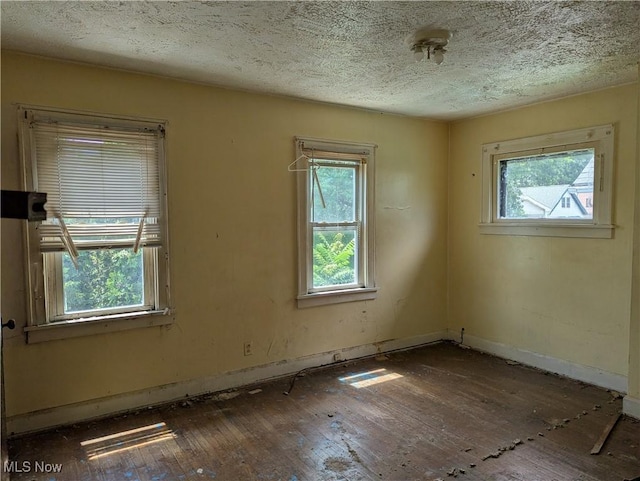 14717 Orinoco Ave, East Cleveland, OH 44112 - spare room featuring hardwood / wood-style flooring and a textured ceiling
