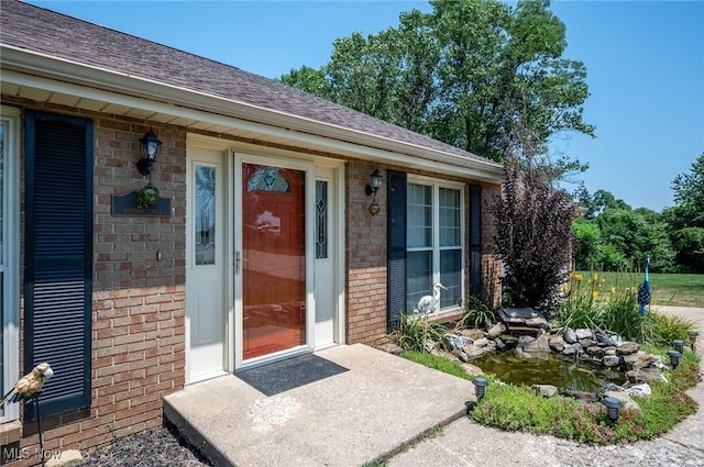 24 Heather Cir, Washington, WV 26181 - doorway to property featuring brick siding and a shingled roof