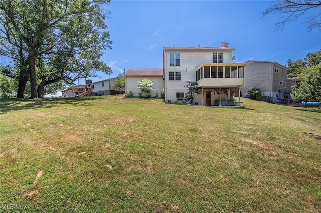 24 Heather Cir, Washington, WV 26181 - back of house with a sunroom, a chimney, and a lawn
