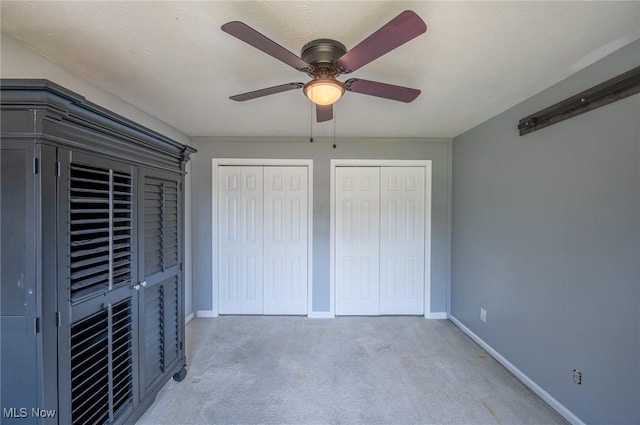 24 Heather Cir, Washington, WV 26181 - unfurnished bedroom with two closets, carpet, and ceiling fan