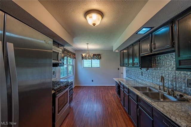 24 Heather Cir, Washington, WV 26181 - kitchen with appliances with stainless steel finishes, tasteful backsplash, dark wood-type flooring, and a chandelier