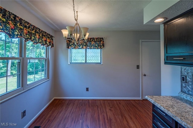 24 Heather Cir, Washington, WV 26181 - unfurnished dining area with a chandelier and dark wood finished floors