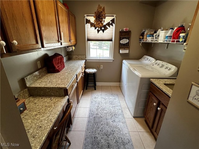660 Rustic Knoll Dr, Kent, OH 44240 - laundry area with cabinet space, washing machine and dryer, and light tile patterned flooring