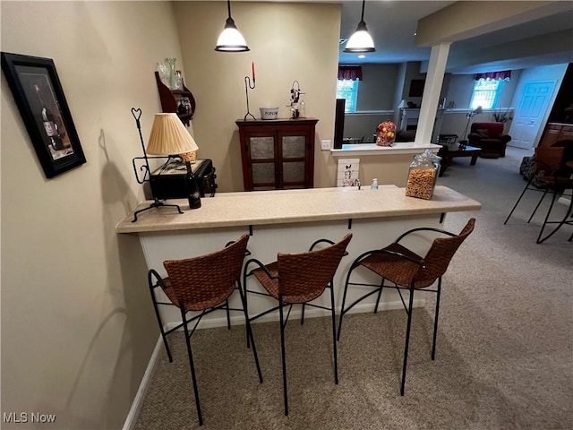 660 Rustic Knoll Dr, Kent, OH 44240 - kitchen with carpet flooring, a kitchen bar, and decorative light fixtures