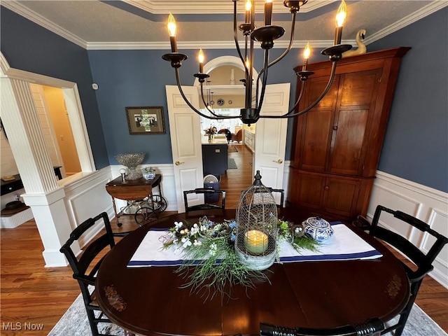 660 Rustic Knoll Dr, Kent, OH 44240 - dining area with wood finished floors, a chandelier, ornamental molding, a wainscoted wall, and a decorative wall