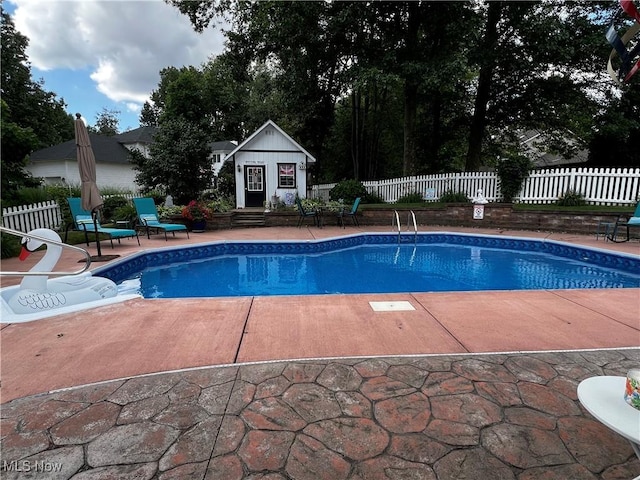 660 Rustic Knoll Dr, Kent, OH 44240 - view of swimming pool featuring a patio area, an outbuilding, and an exterior structure