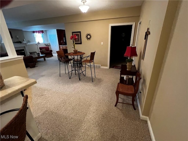 660 Rustic Knoll Dr, Kent, OH 44240 - carpeted dining area featuring a fireplace and baseboards