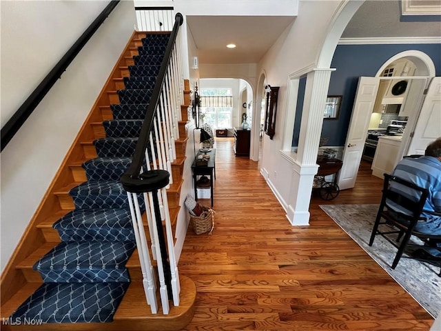 660 Rustic Knoll Dr, Kent, OH 44240 - entrance foyer featuring arched walkways, wood finished floors, stairway, ornate columns, and ornamental molding