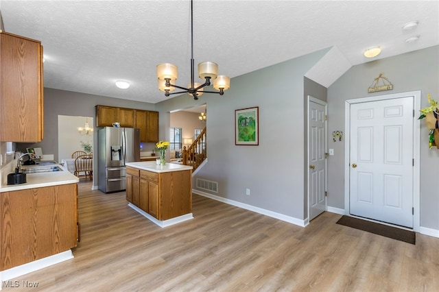1648 E Turkey Run Dr, Newark, OH 43055 - kitchen featuring stainless steel fridge, a chandelier, brown cabinetry, light wood-type flooring, and light countertops