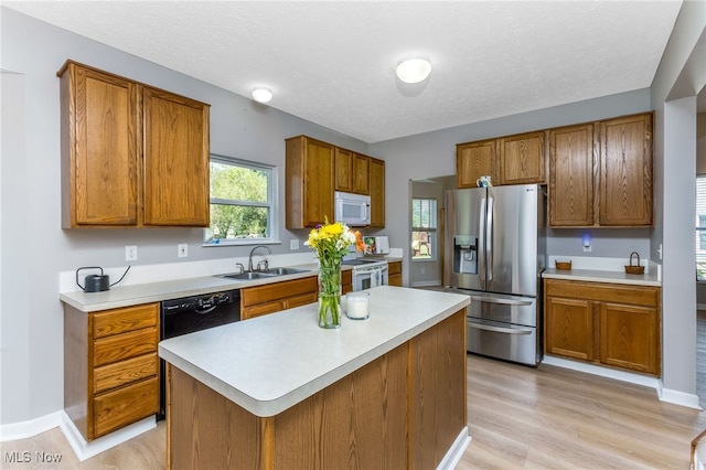 1648 E Turkey Run Dr, Newark, OH 43055 - kitchen with stainless steel fridge with ice dispenser, white microwave, brown cabinetry, light countertops, and a textured ceiling