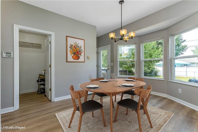 1648 E Turkey Run Dr, Newark, OH 43055 - dining area with a chandelier, healthy amount of natural light, and light wood-type flooring