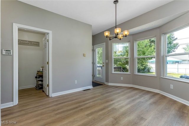 1648 E Turkey Run Dr, Newark, OH 43055 - unfurnished dining area with a chandelier, light wood-type flooring, healthy amount of natural light, and vaulted ceiling