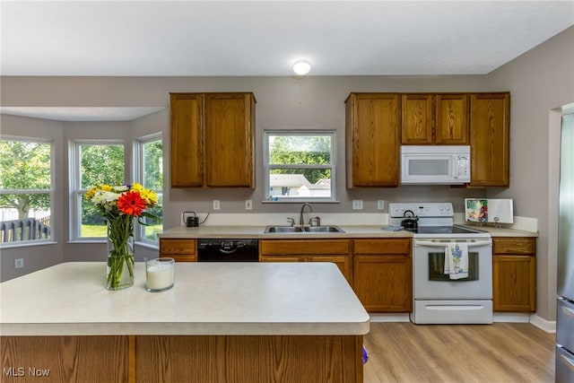 1648 E Turkey Run Dr, Newark, OH 43055 - kitchen featuring white appliances, brown cabinets, light countertops, and light wood-style floors