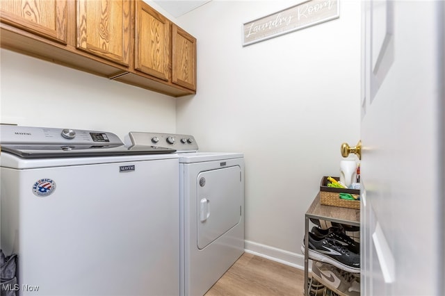 1648 E Turkey Run Dr, Newark, OH 43055 - washroom featuring cabinet space, washer and dryer, and light wood-style floors