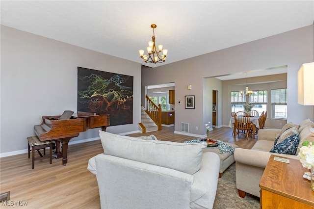 1648 E Turkey Run Dr, Newark, OH 43055 - living area with a chandelier, light wood finished floors, and stairway