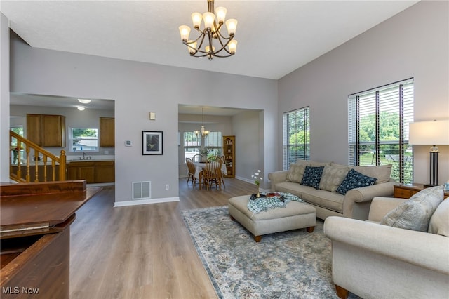 1648 E Turkey Run Dr, Newark, OH 43055 - living area with a chandelier, light wood-style flooring, and stairs