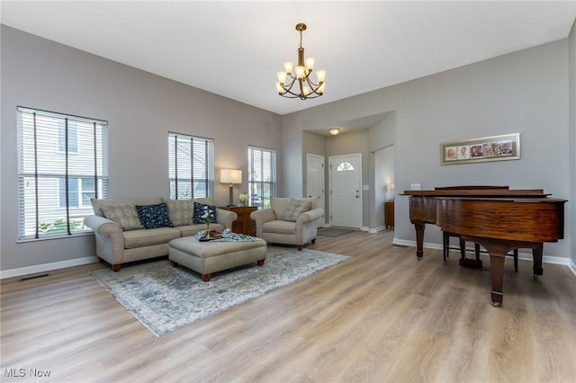 1648 E Turkey Run Dr, Newark, OH 43055 - living area with a chandelier, plenty of natural light, and light wood-style flooring