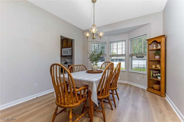 1648 E Turkey Run Dr, Newark, OH 43055 - dining space with light wood-style floors and a chandelier
