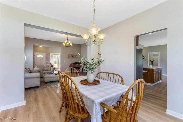 1648 E Turkey Run Dr, Newark, OH 43055 - dining area with a chandelier and light wood-type flooring