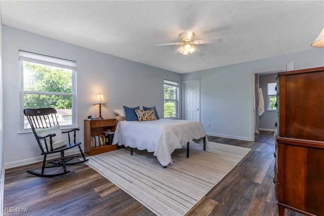 1648 E Turkey Run Dr, Newark, OH 43055 - bedroom featuring multiple windows, dark wood-style floors, a textured ceiling, and a ceiling fan