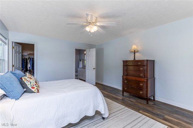 1648 E Turkey Run Dr, Newark, OH 43055 - bedroom with wood finished floors, a textured ceiling, a ceiling fan, a closet, and ensuite bath